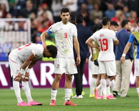 Iran players react after their draw with Egypt